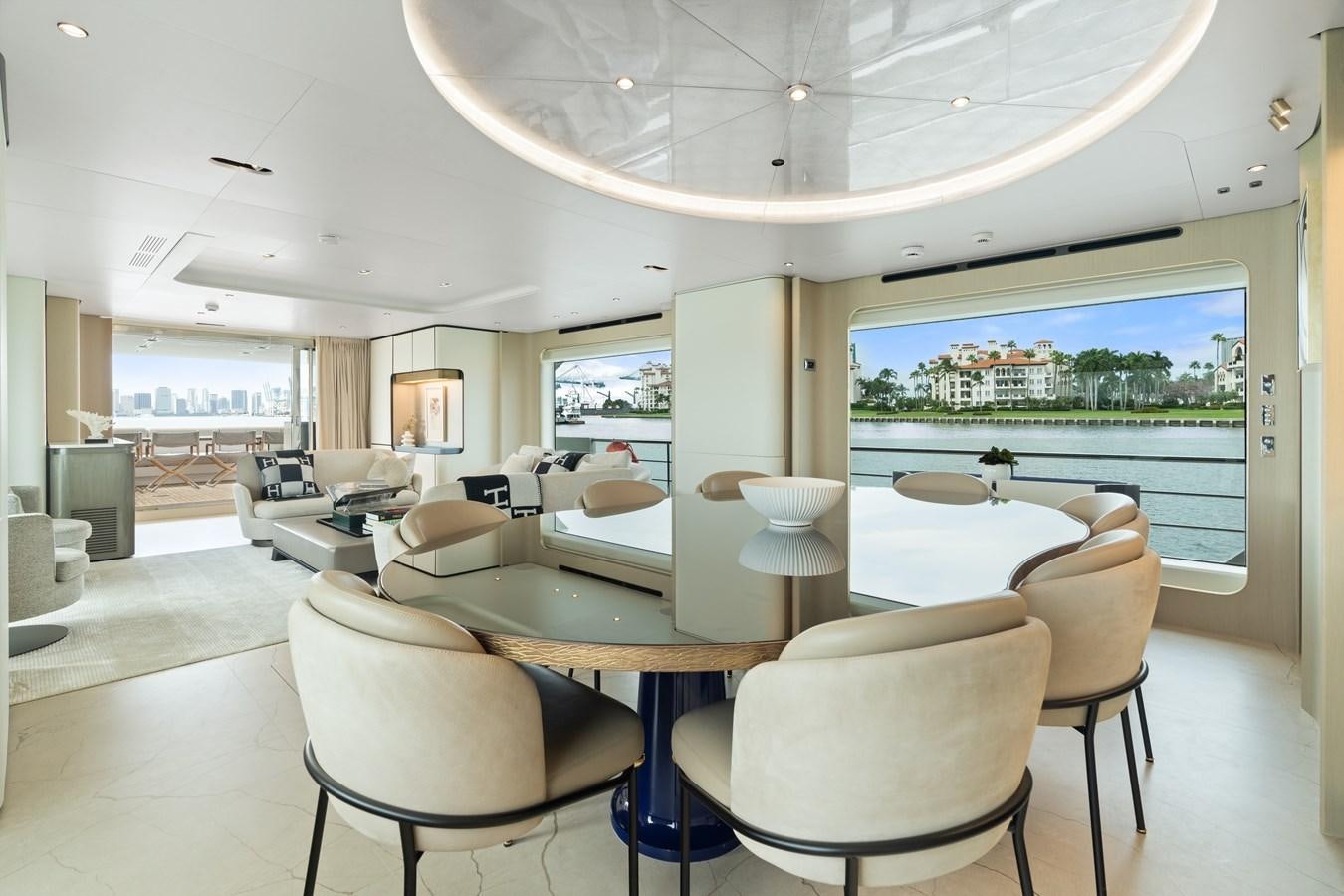 a room with tables and chairs aboard Y Yacht for Sale