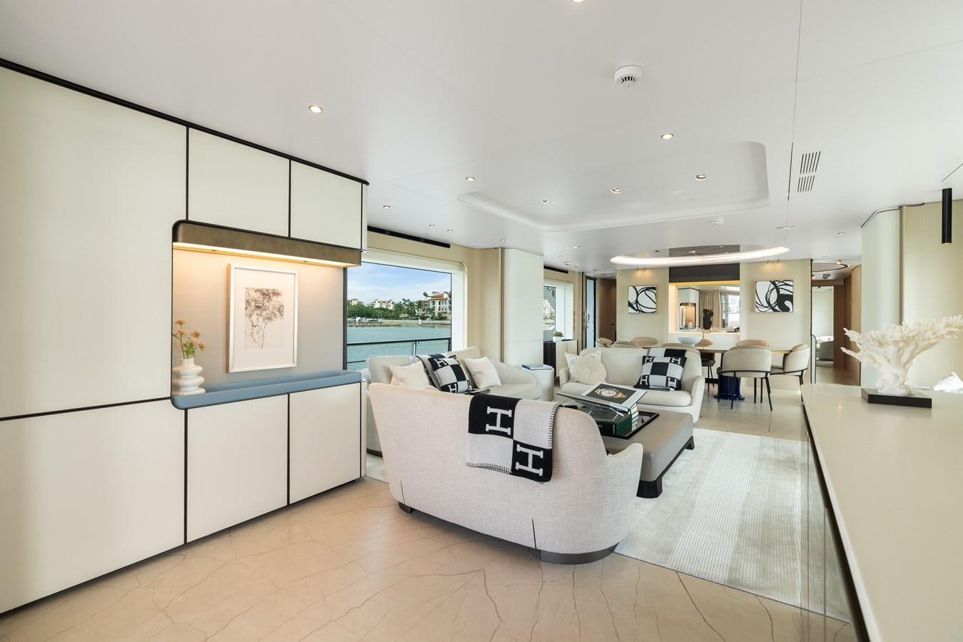 a living room with white furniture aboard Y Yacht for Sale
