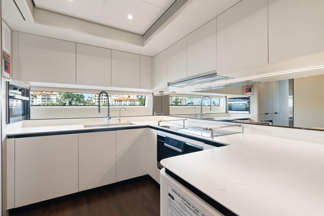 a kitchen with white cabinets aboard Y Yacht for Sale