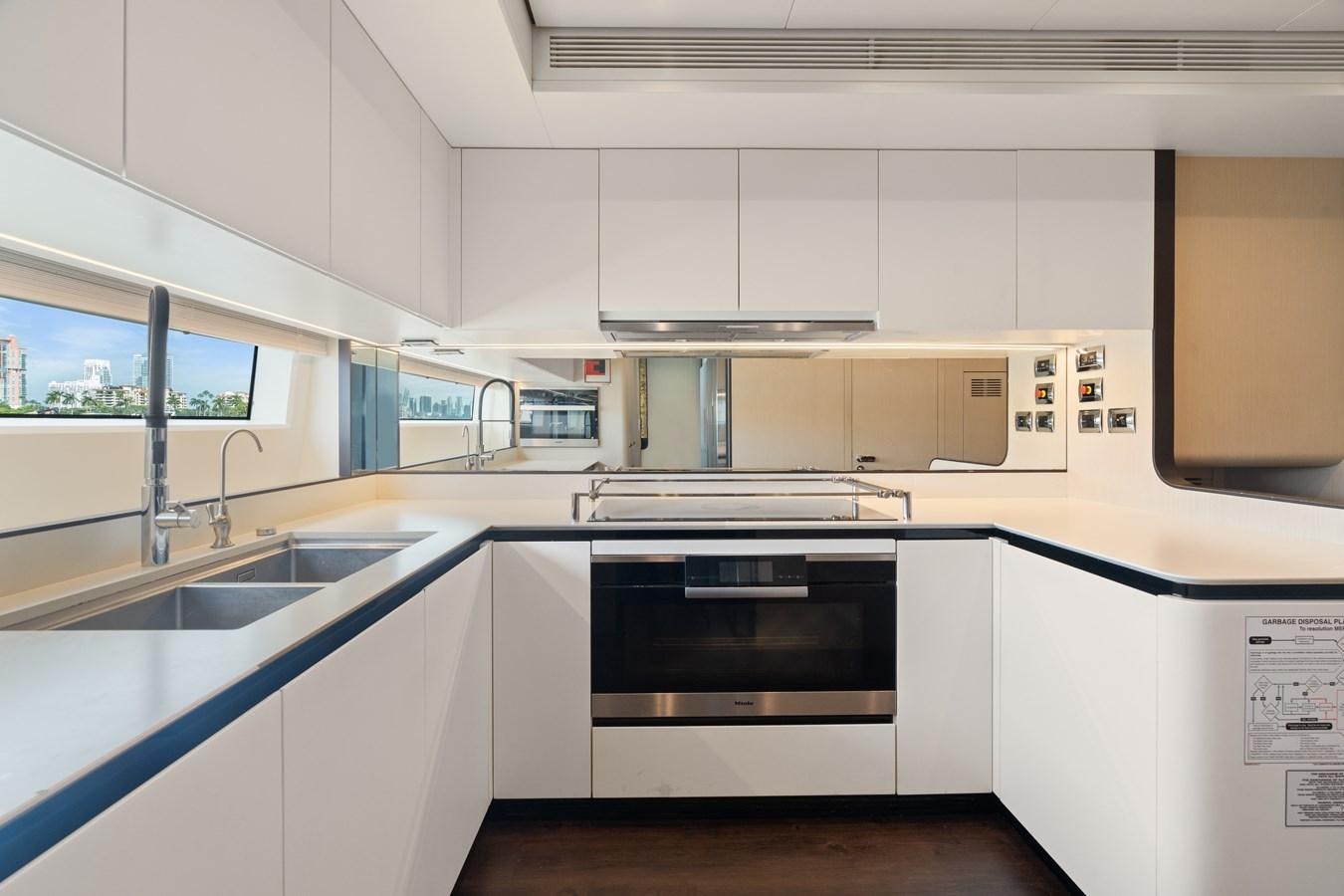 a kitchen with white cabinets aboard Y Yacht for Sale