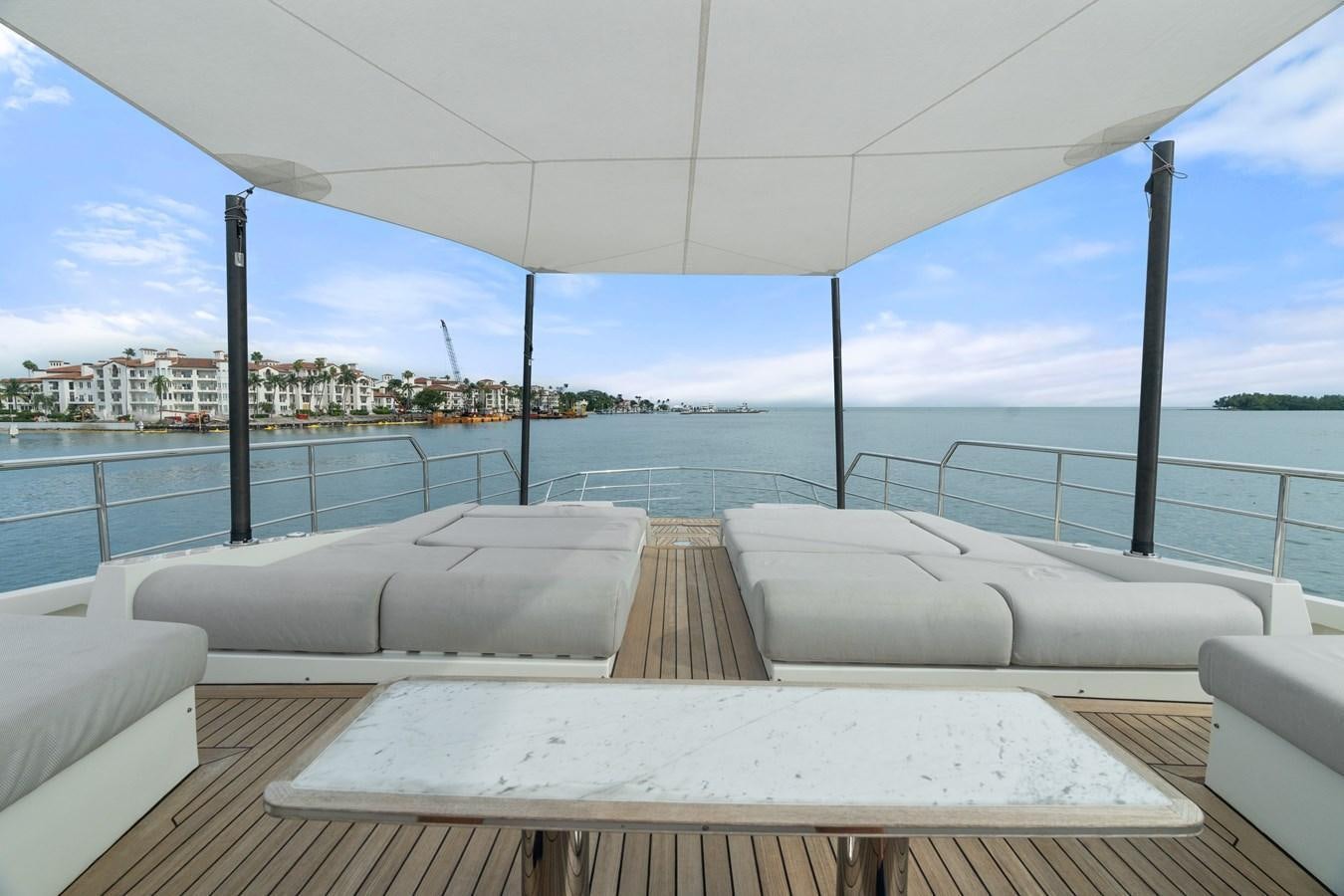 a deck with a view of a city and water aboard Y Yacht for Sale