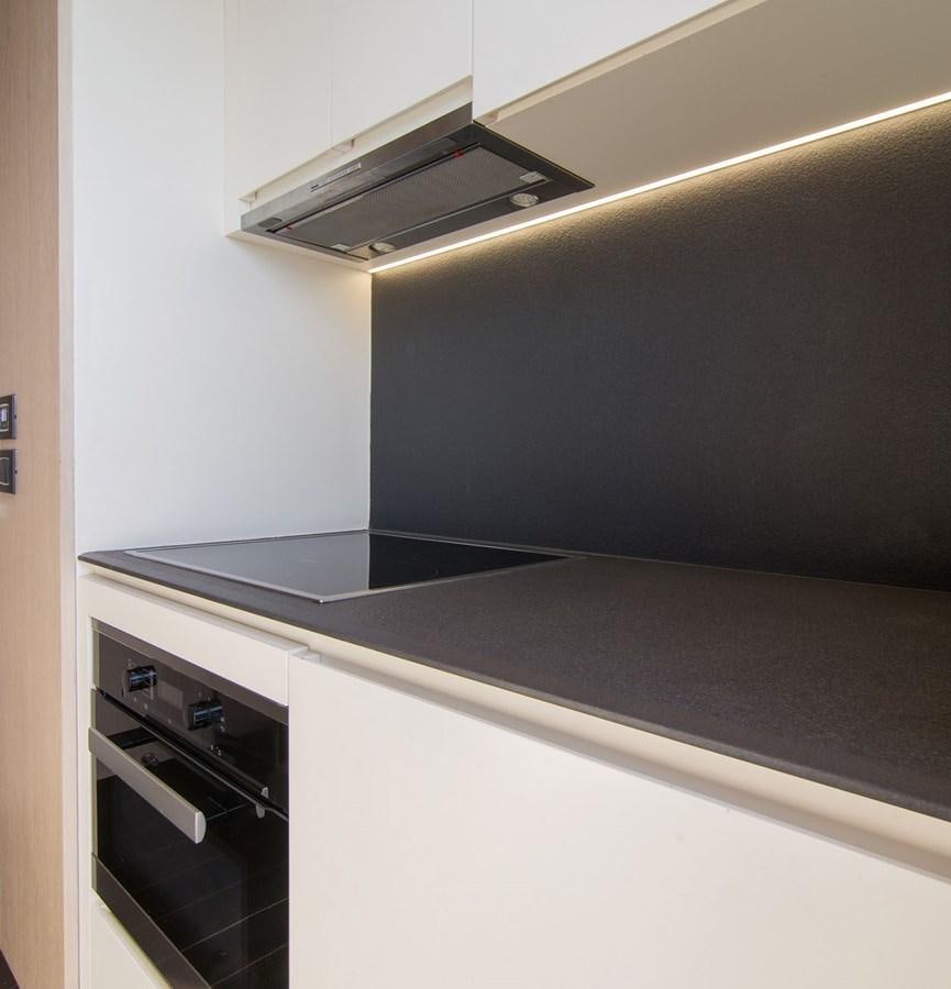 a kitchen with a stove and a microwave aboard ALEX I Yacht for Sale