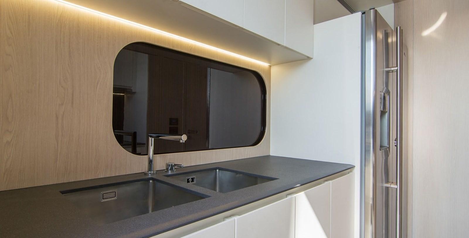 a kitchen with a sink and a mirror aboard ALEX I Yacht for Sale