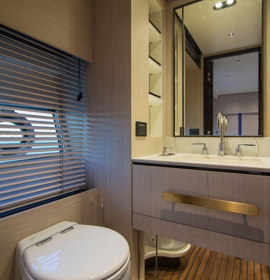 a bathroom with a tub sink and toilet aboard ALEX I Yacht for Sale