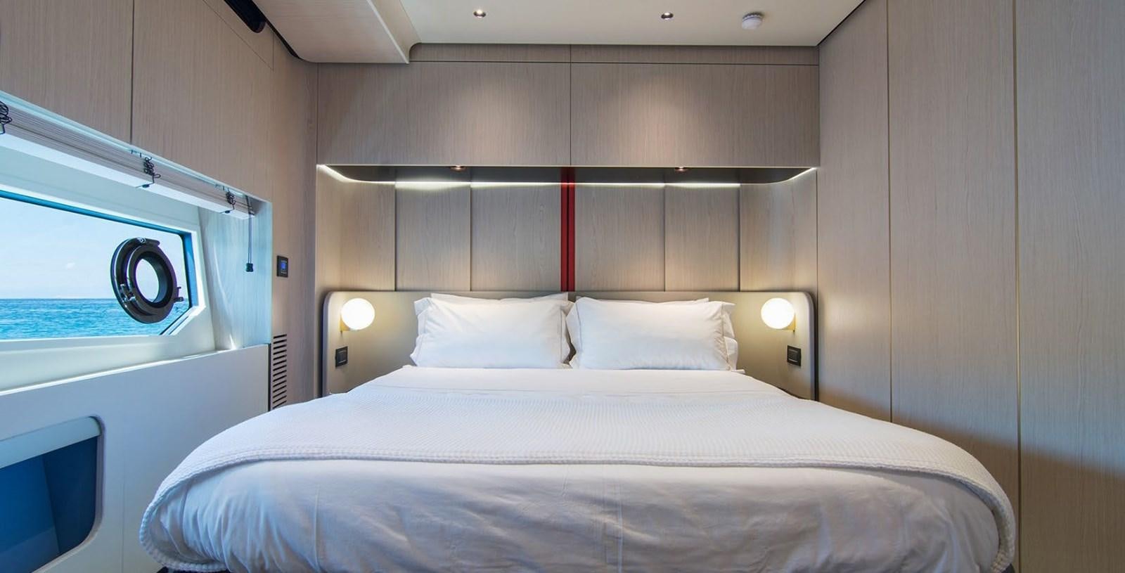 a bed with white sheets aboard ALEX I Yacht for Sale