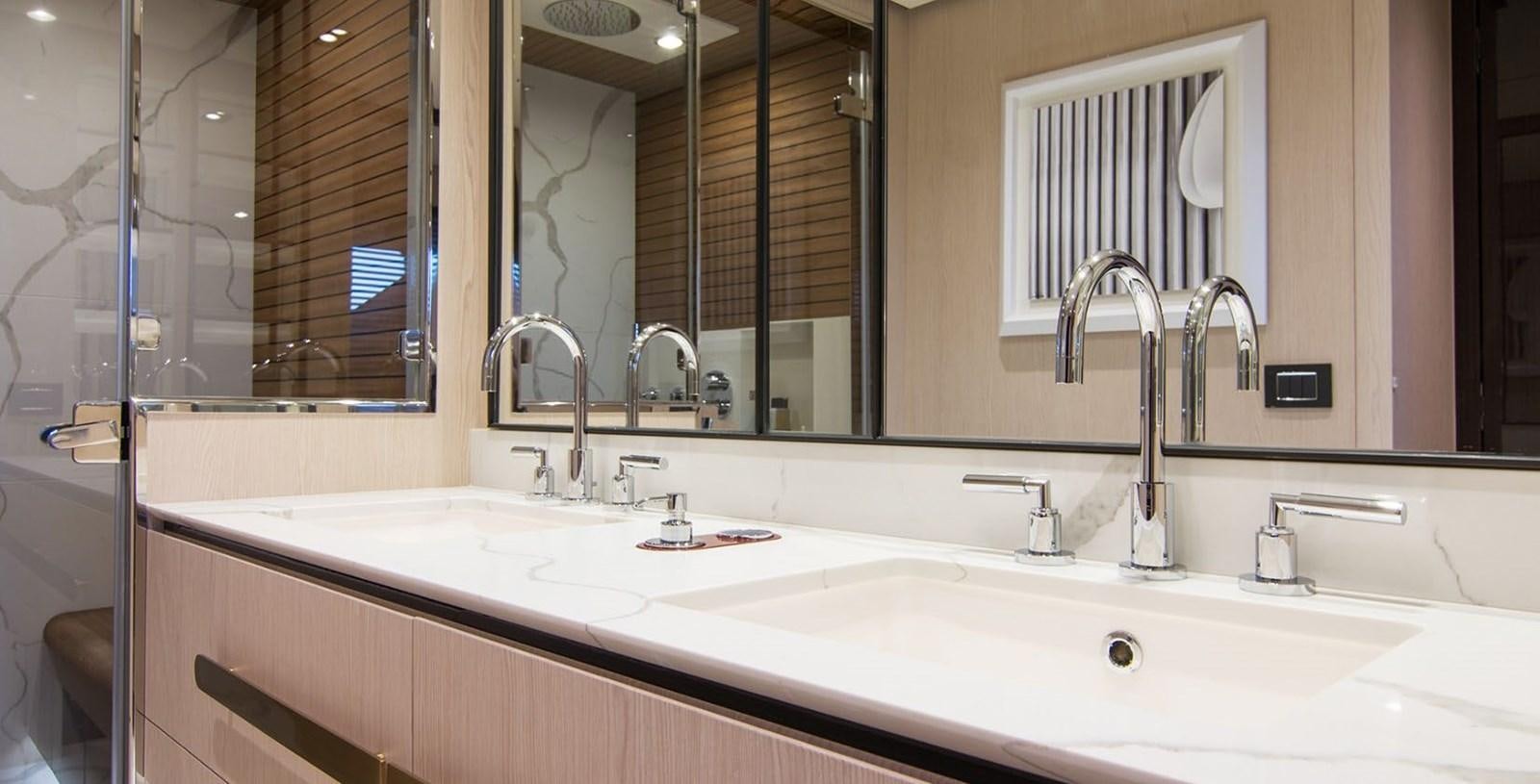 a bathroom with a large mirror aboard ALEX I Yacht for Sale