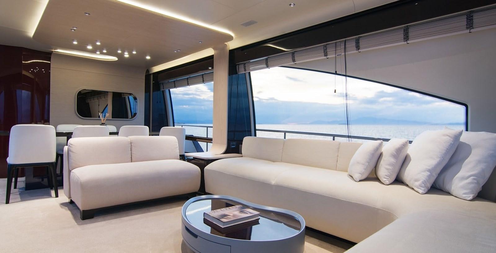 a room with a couch and a table and a window aboard ALEX I Yacht for Sale