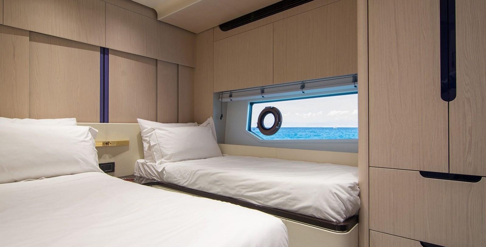 a room with two beds aboard ALEX I Yacht for Sale