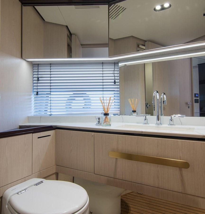 a bathroom with a toilet and a sink aboard ALEX I Yacht for Sale