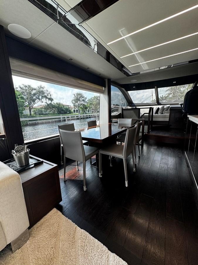 a large room with a table and chairs aboard JOURNEY Yacht for Sale