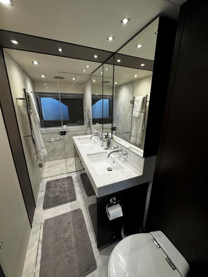 a bathroom with a large mirror aboard JOURNEY Yacht for Sale
