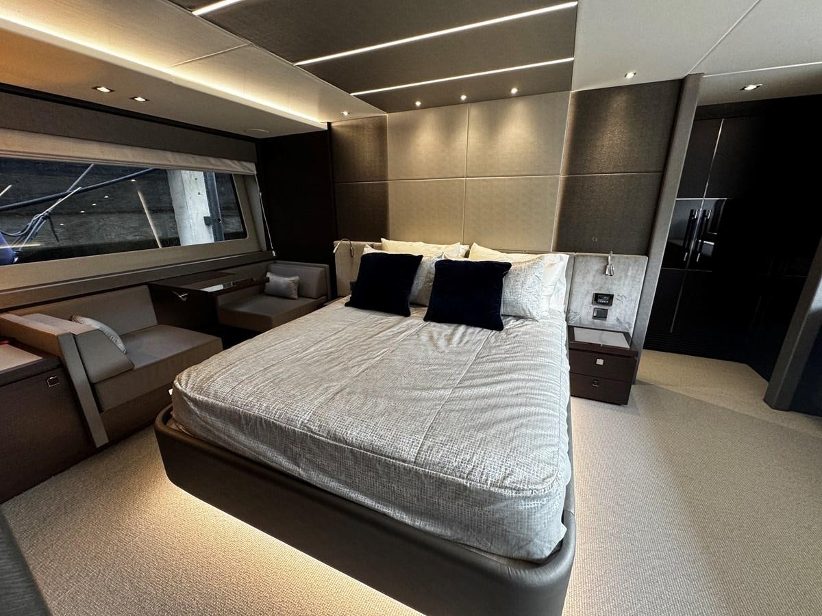 a room with a bed and a window aboard JOURNEY Yacht for Sale