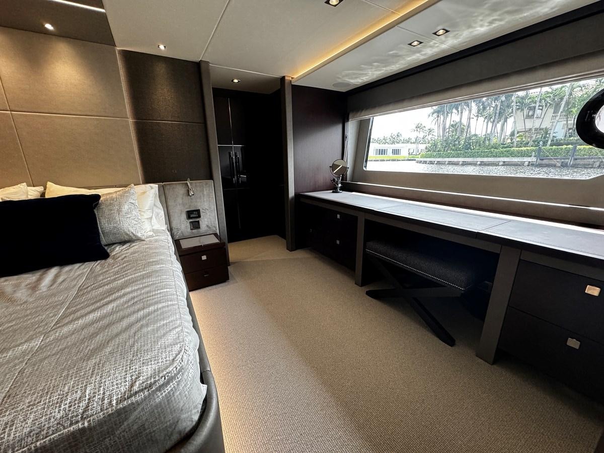 a room with a bed and a desk aboard JOURNEY Yacht for Sale