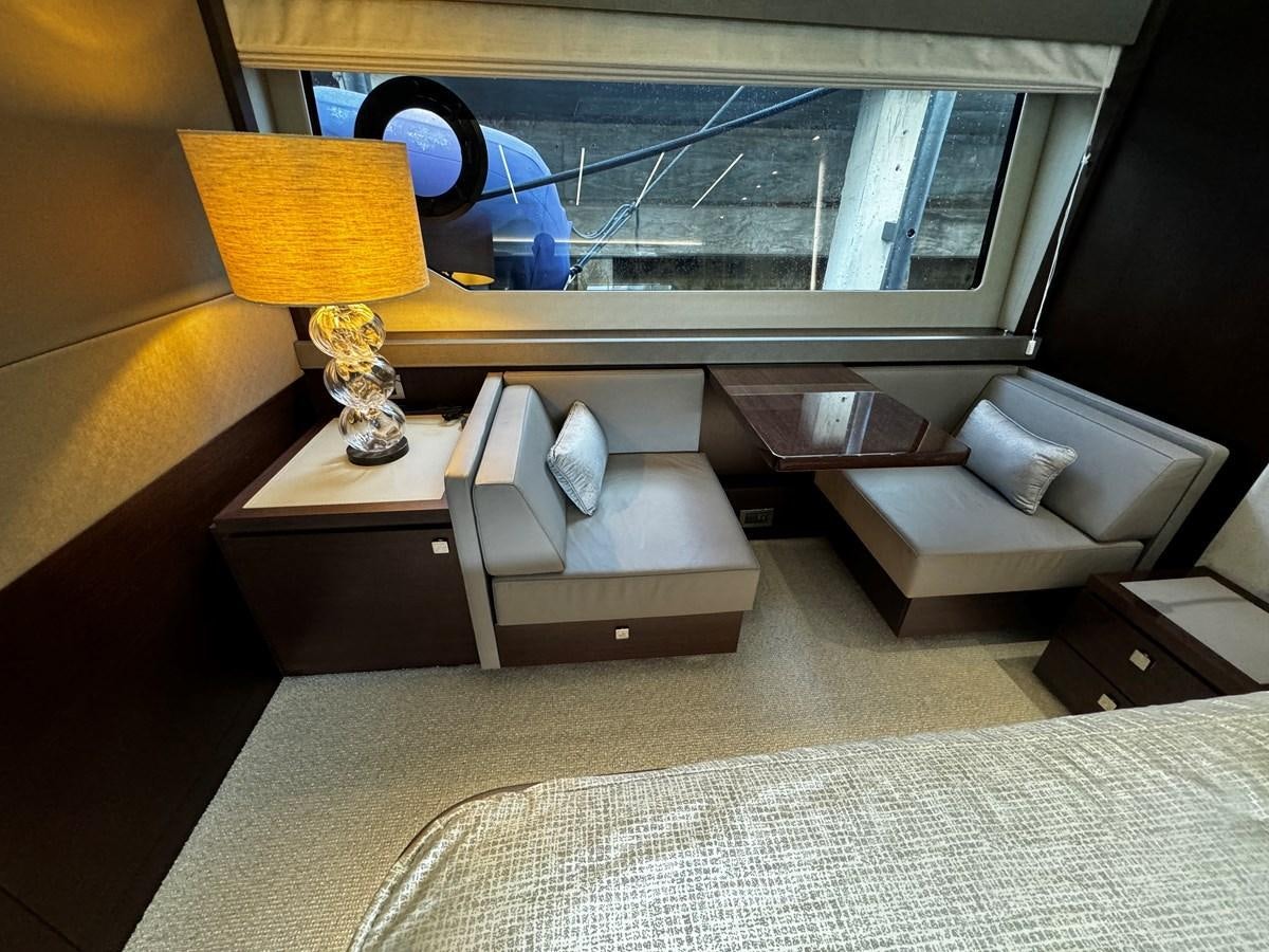 a room with a bed and a lamp aboard JOURNEY Yacht for Sale