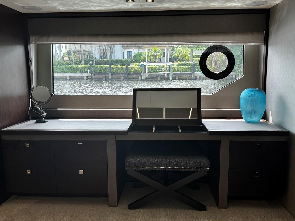 a room with a desk and a large window aboard JOURNEY Yacht for Sale
