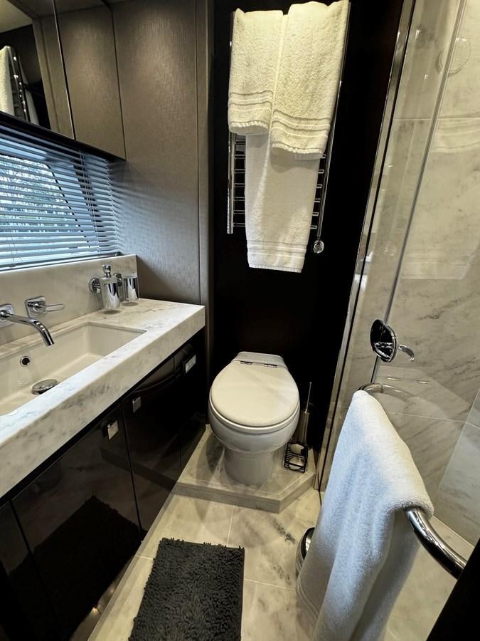 a bathroom with a toilet and sink aboard JOURNEY Yacht for Sale