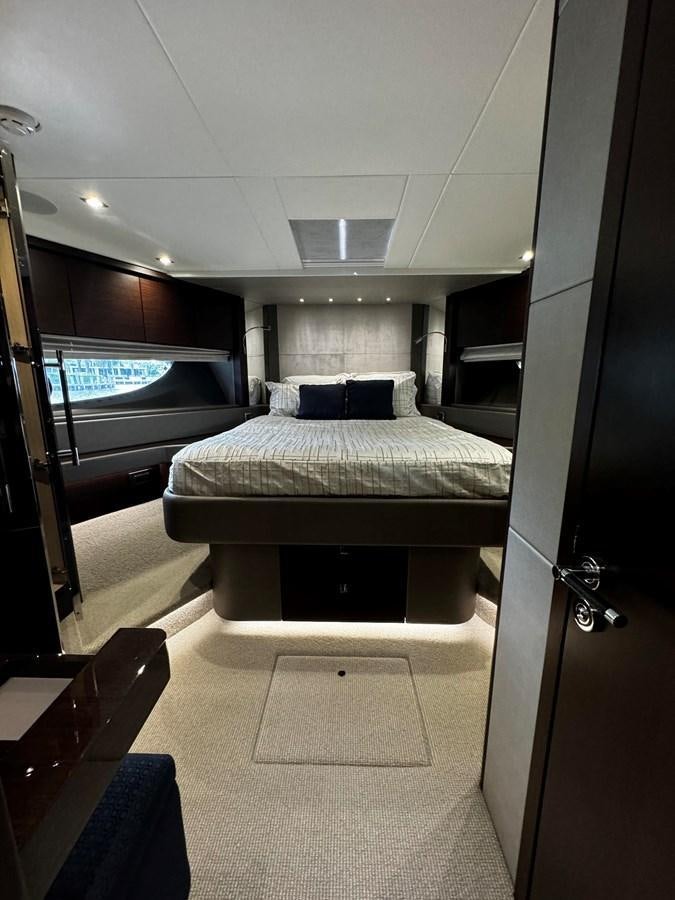 a room with a bed and a chair aboard JOURNEY Yacht for Sale