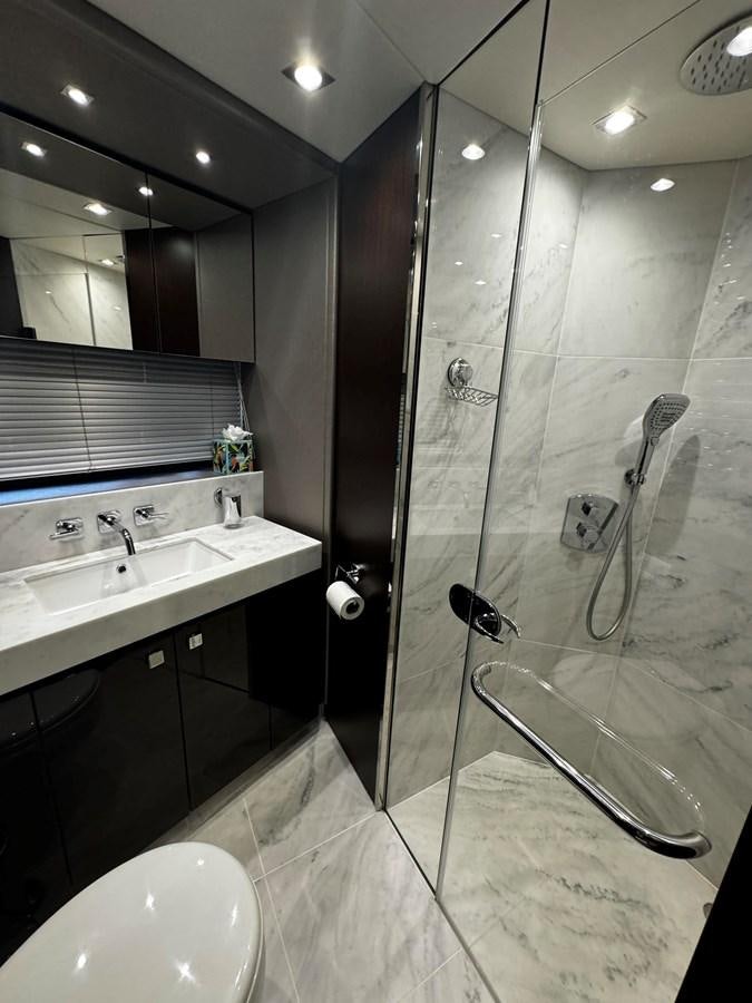 a bathroom with a glass shower aboard JOURNEY Yacht for Sale