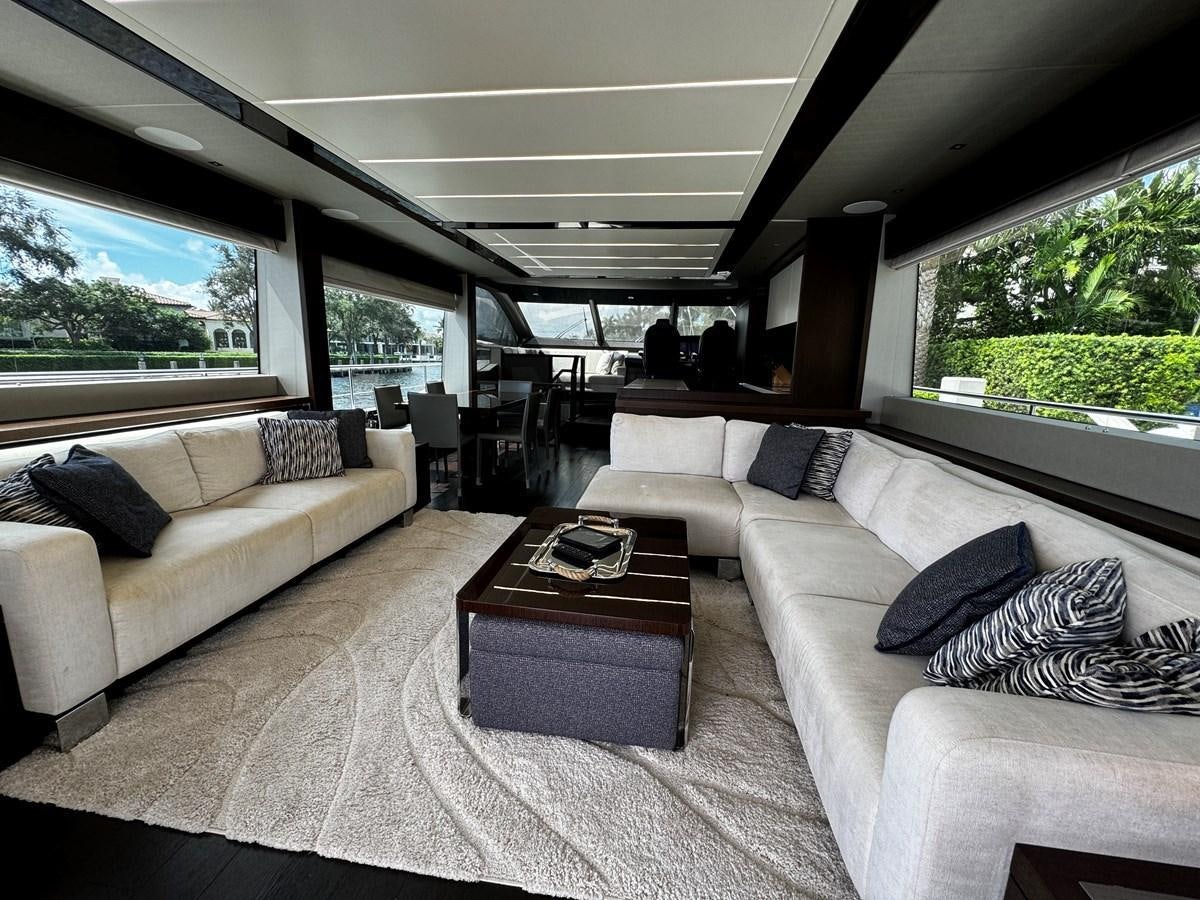 a living room with couches and a table aboard JOURNEY Yacht for Sale