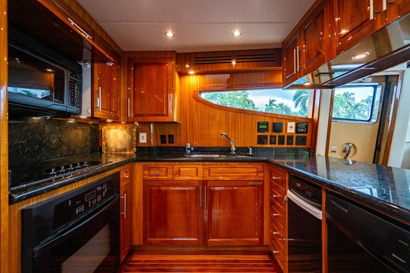 a kitchen with wooden cabinets aboard TOP SHELF Yacht for Sale