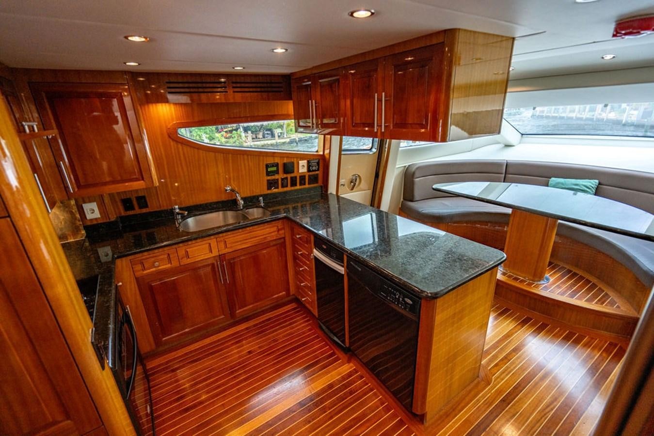 a kitchen with wooden cabinets aboard TOP SHELF Yacht for Sale