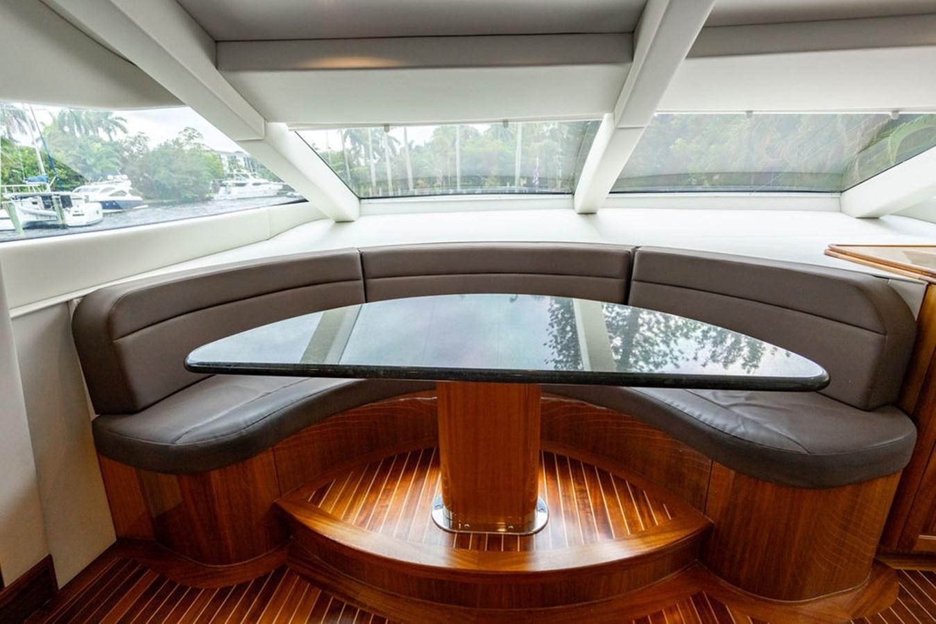 a table and chairs in a room aboard TOP SHELF Yacht for Sale