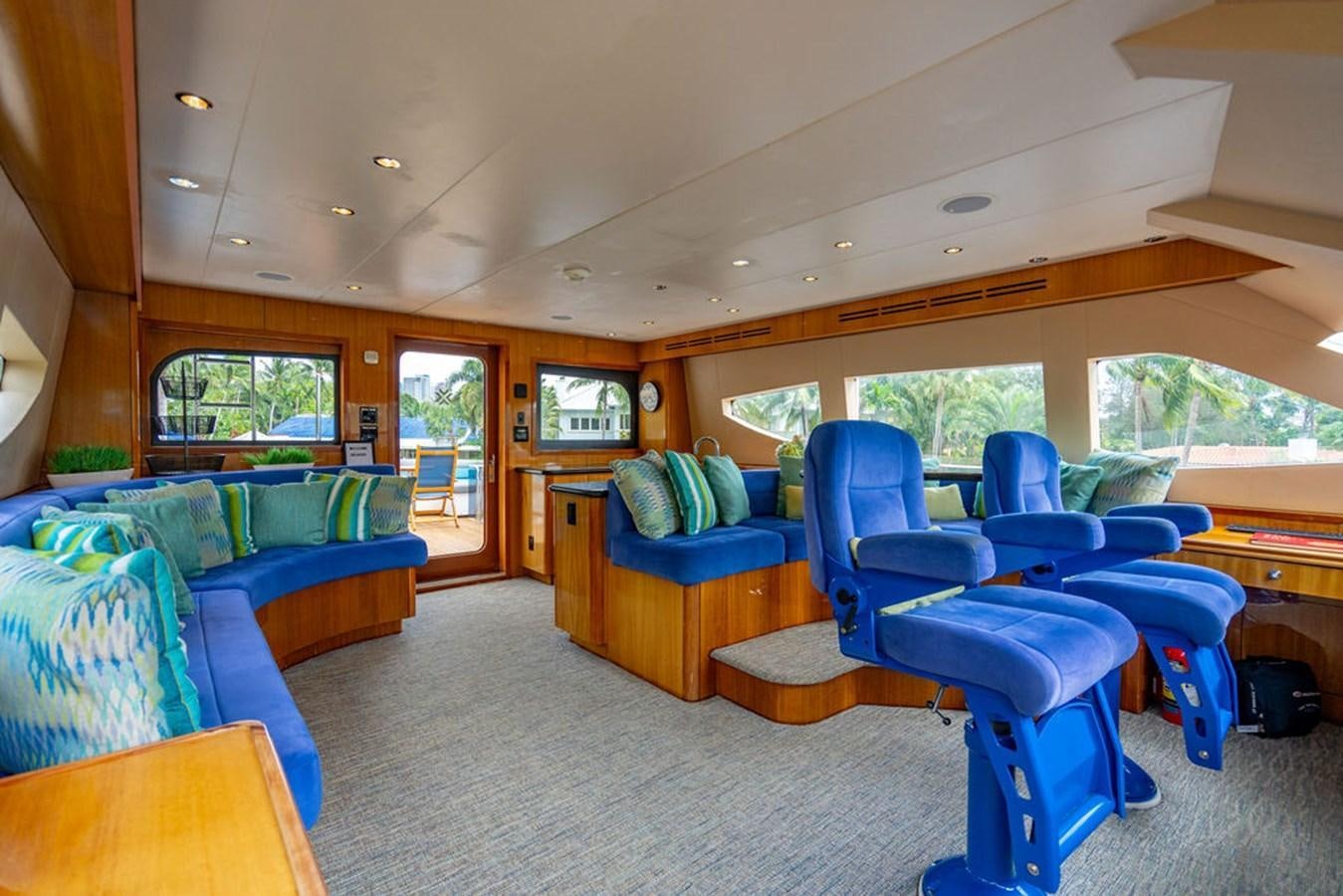 a room with a couch and a table aboard TOP SHELF Yacht for Sale