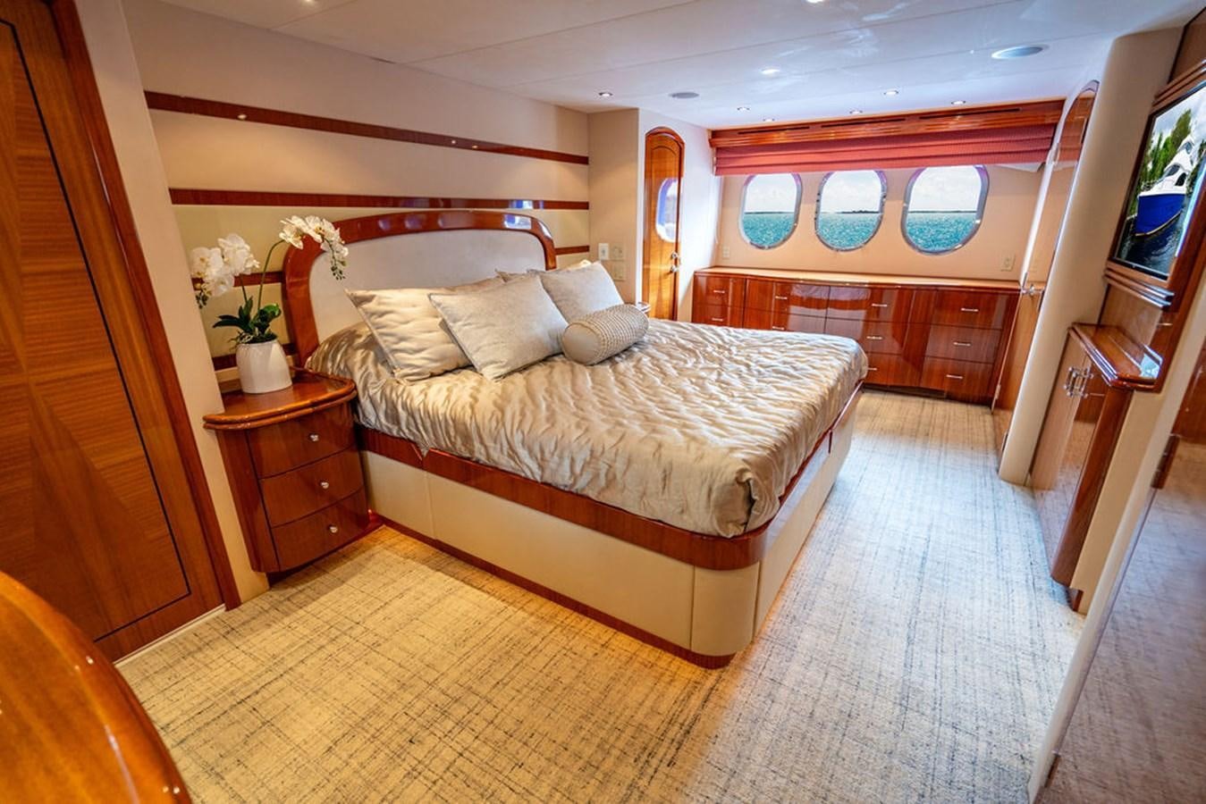 a bedroom with a bed and a desk aboard TOP SHELF Yacht for Sale