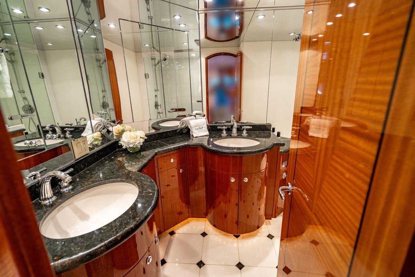a bathroom with a sink and a mirror aboard TOP SHELF Yacht for Sale