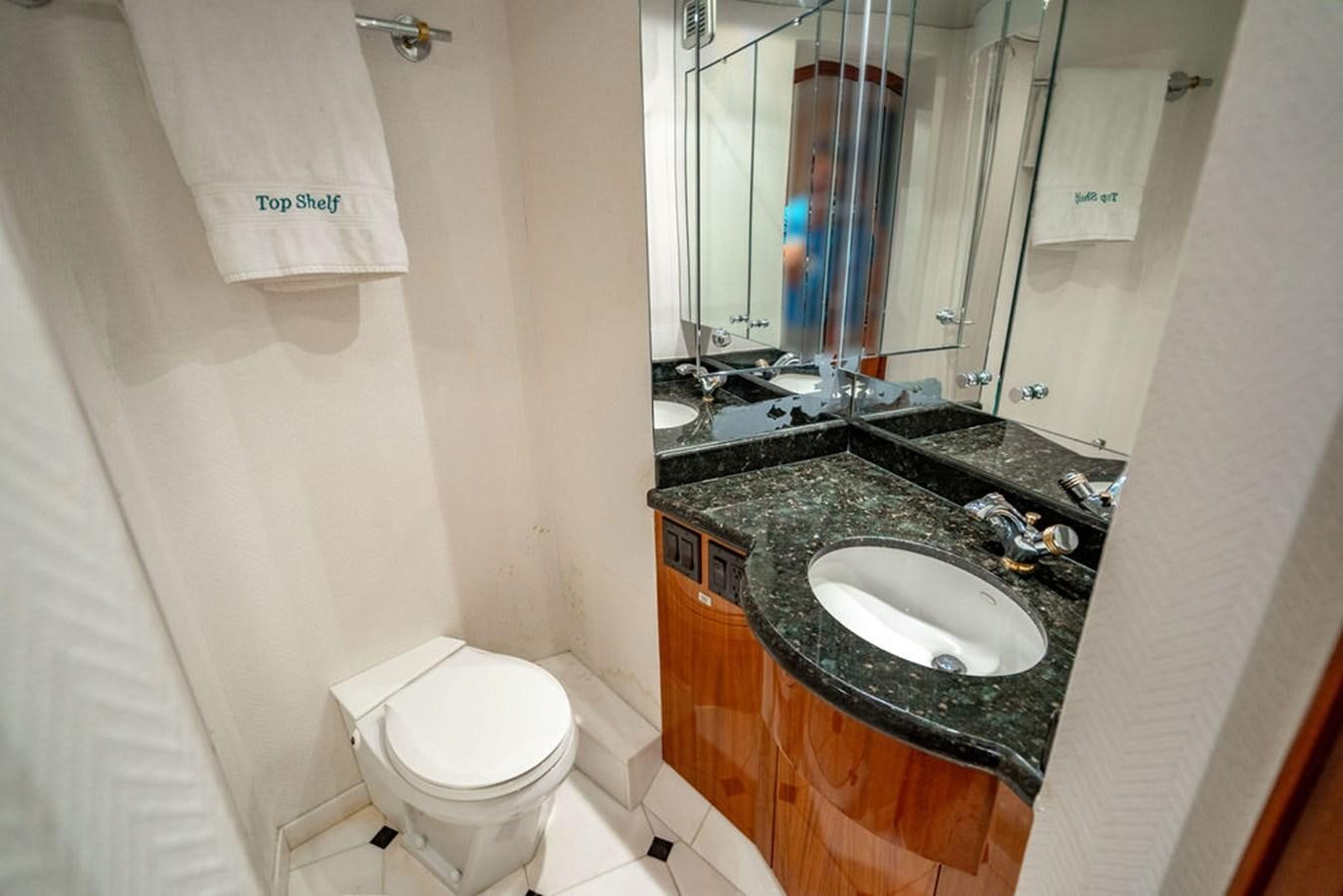 a bathroom with a black countertop aboard TOP SHELF Yacht for Sale