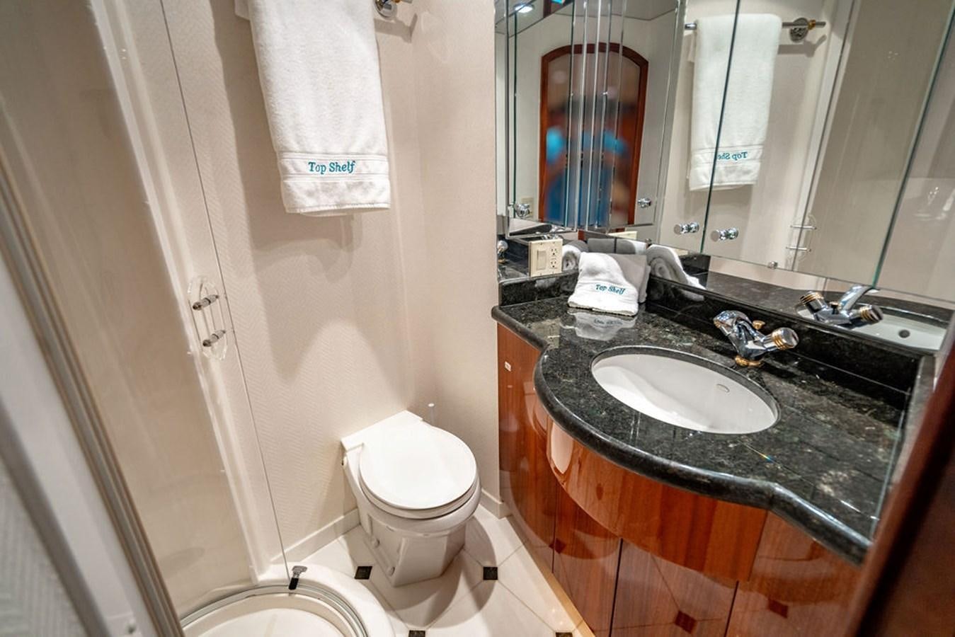 a bathroom with a black countertop aboard TOP SHELF Yacht for Sale
