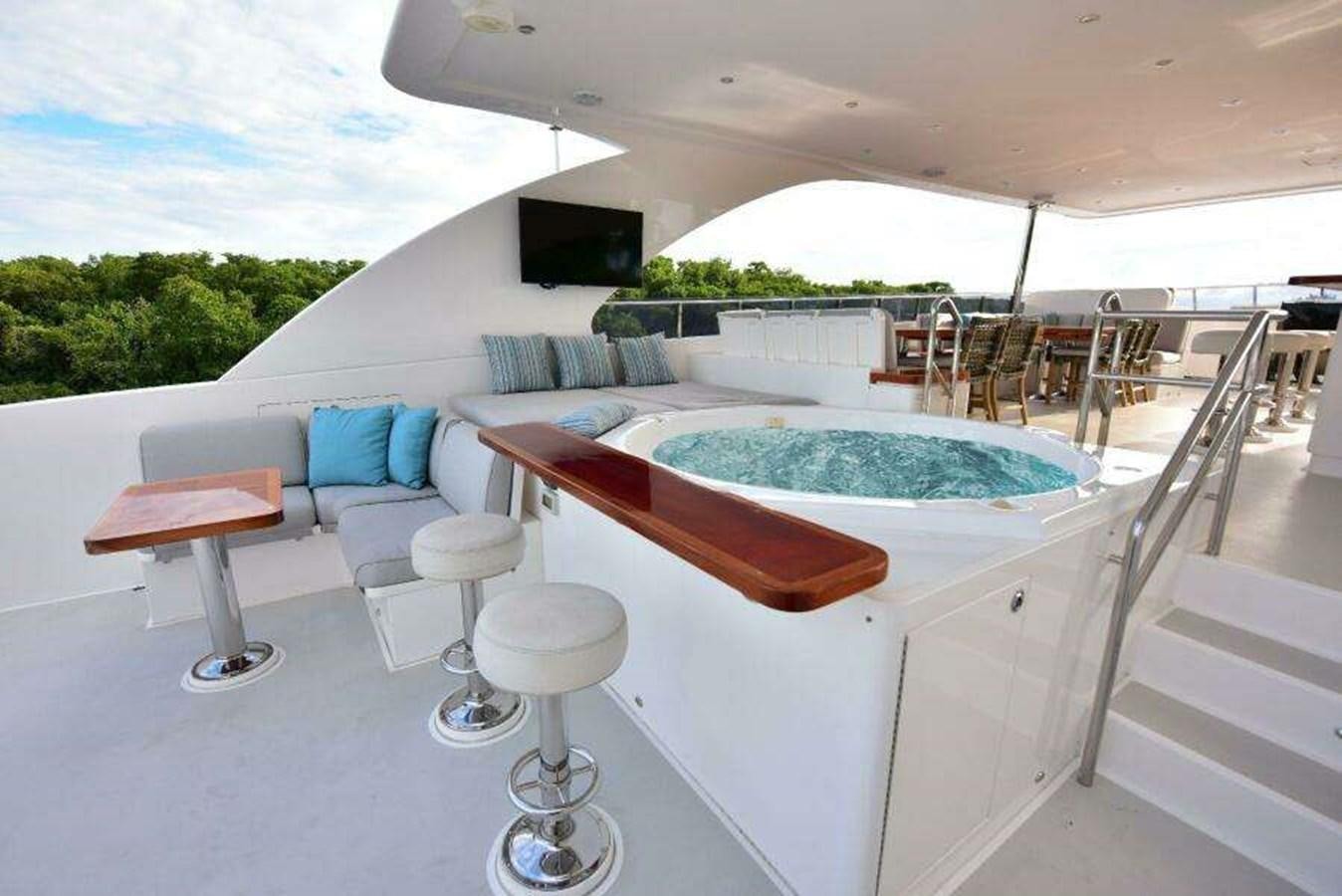 a large white lounge chair next to a pool table and stools aboard RENAISSANCE Yacht for Sale