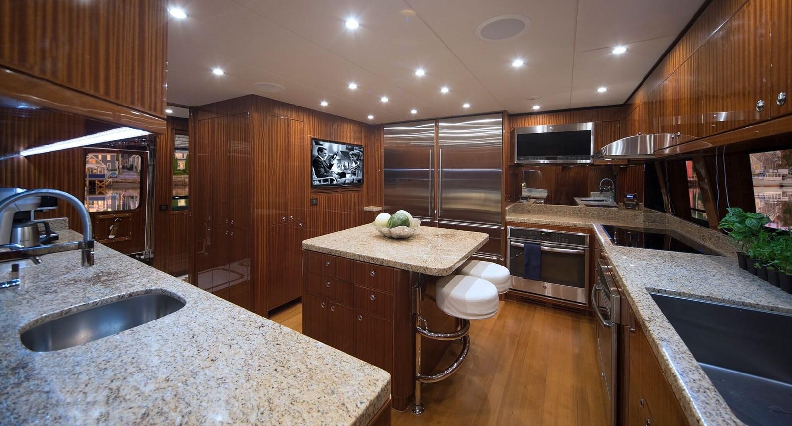 a kitchen with wooden cabinets aboard RENAISSANCE Yacht for Sale