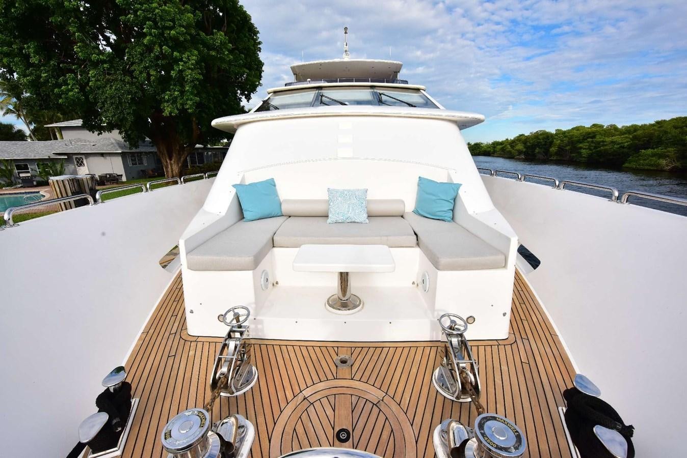 a white boat with blue and white pillows on it aboard RENAISSANCE Yacht for Sale