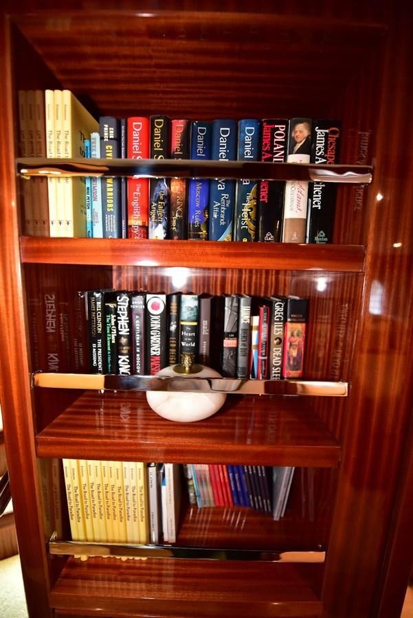 a shelf with books on it aboard RENAISSANCE Yacht for Sale