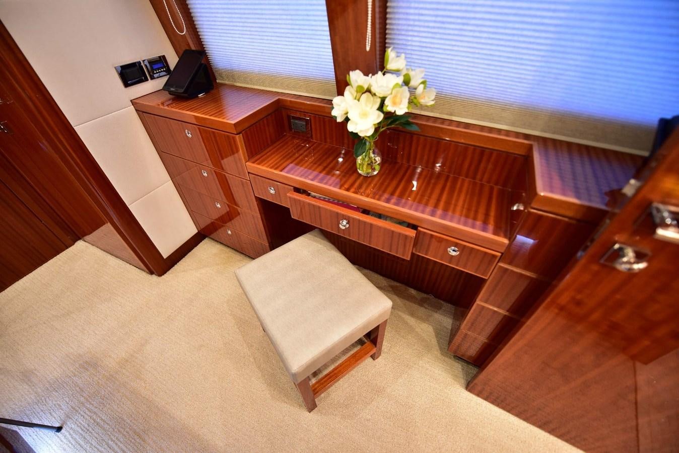 a wooden desk with a vase of flowers on it aboard RENAISSANCE Yacht for Sale