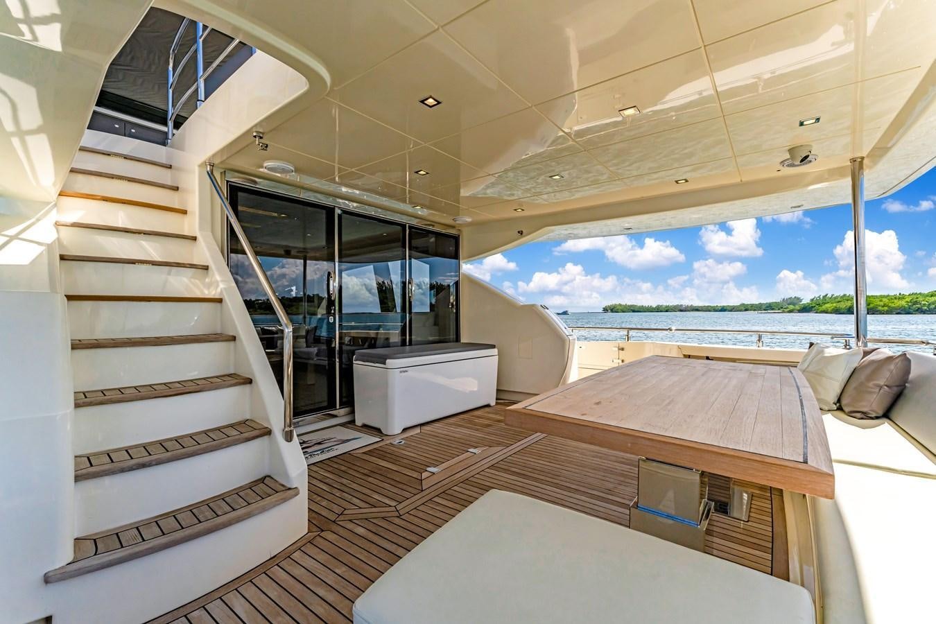 a modern looking room with a glass door and a balcony aboard SEADUCTION Yacht for Sale