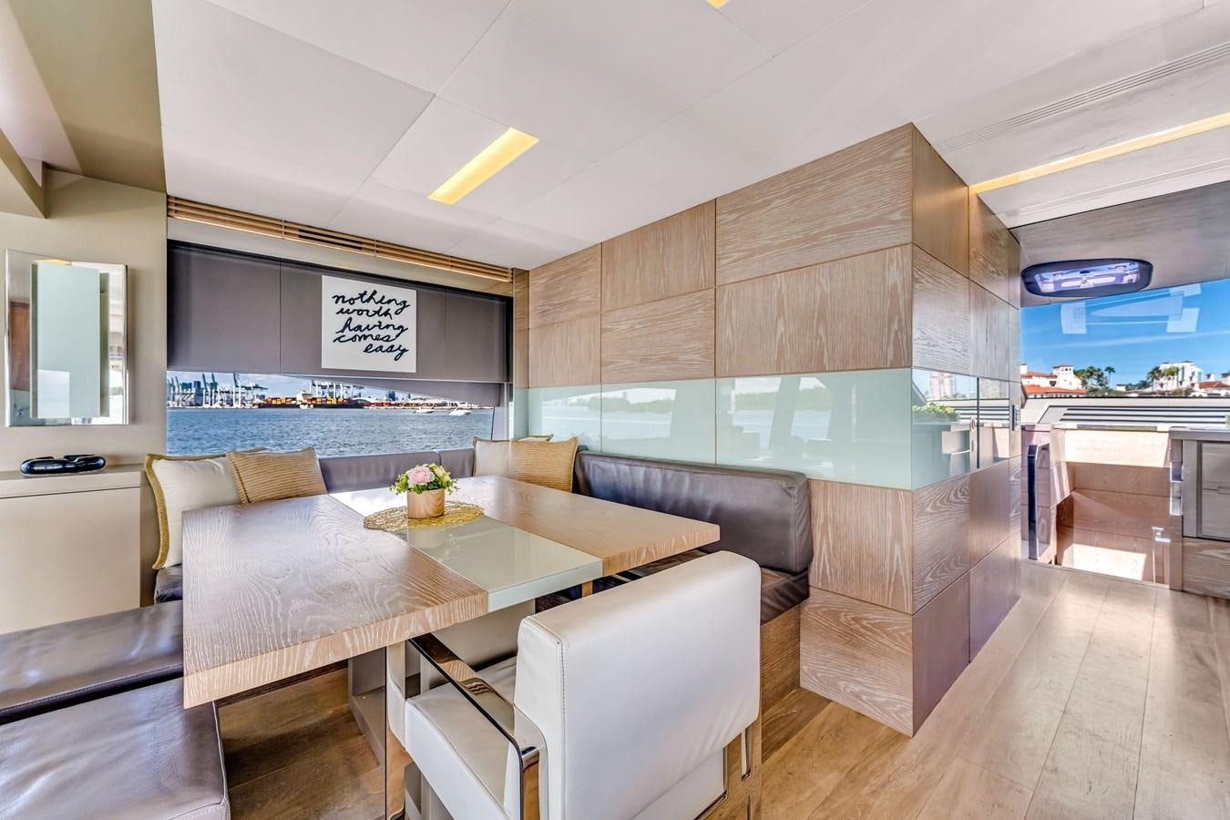 a room with a table and chairs aboard SEADUCTION Yacht for Sale