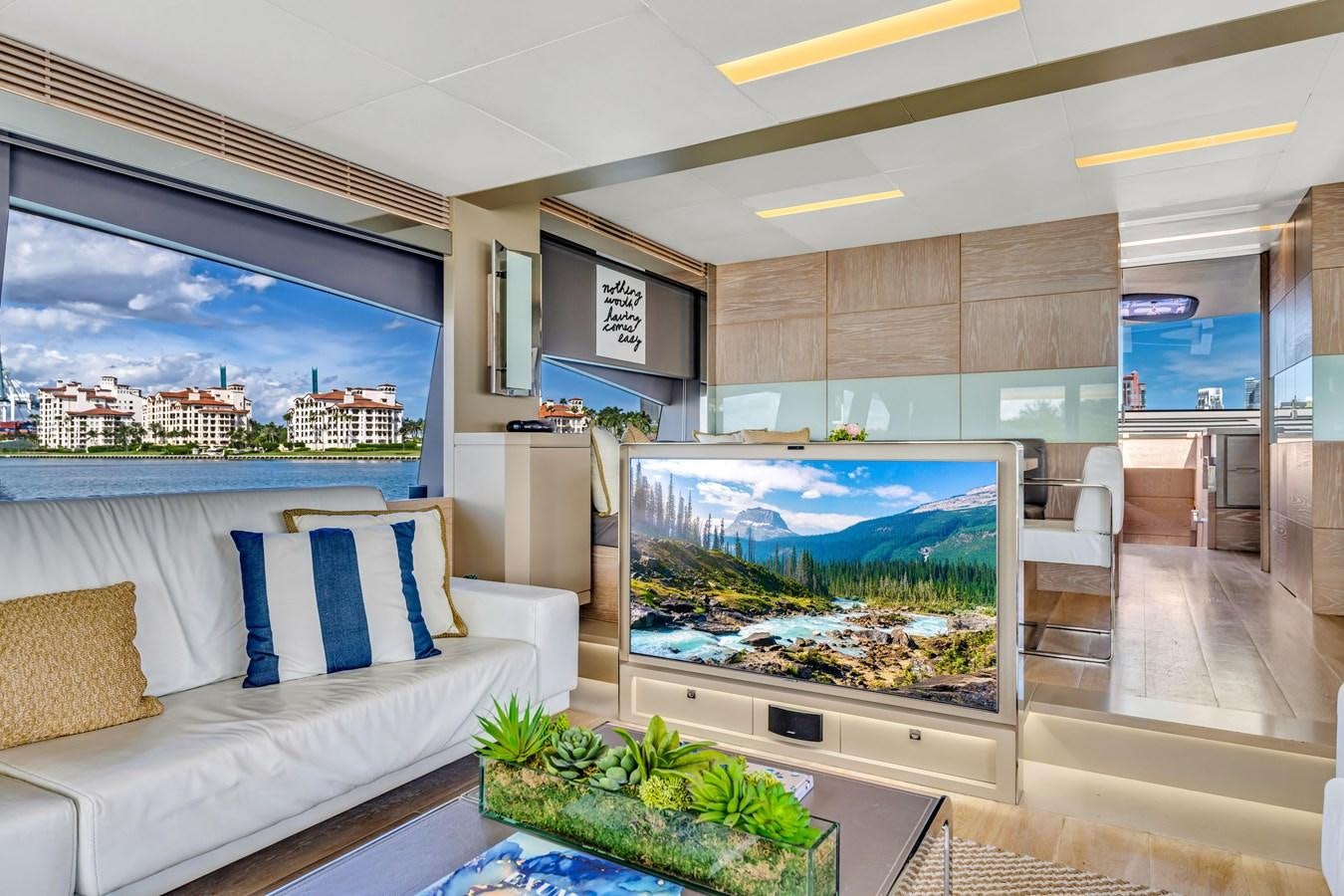 a living room with a large screen aboard SEADUCTION Yacht for Sale