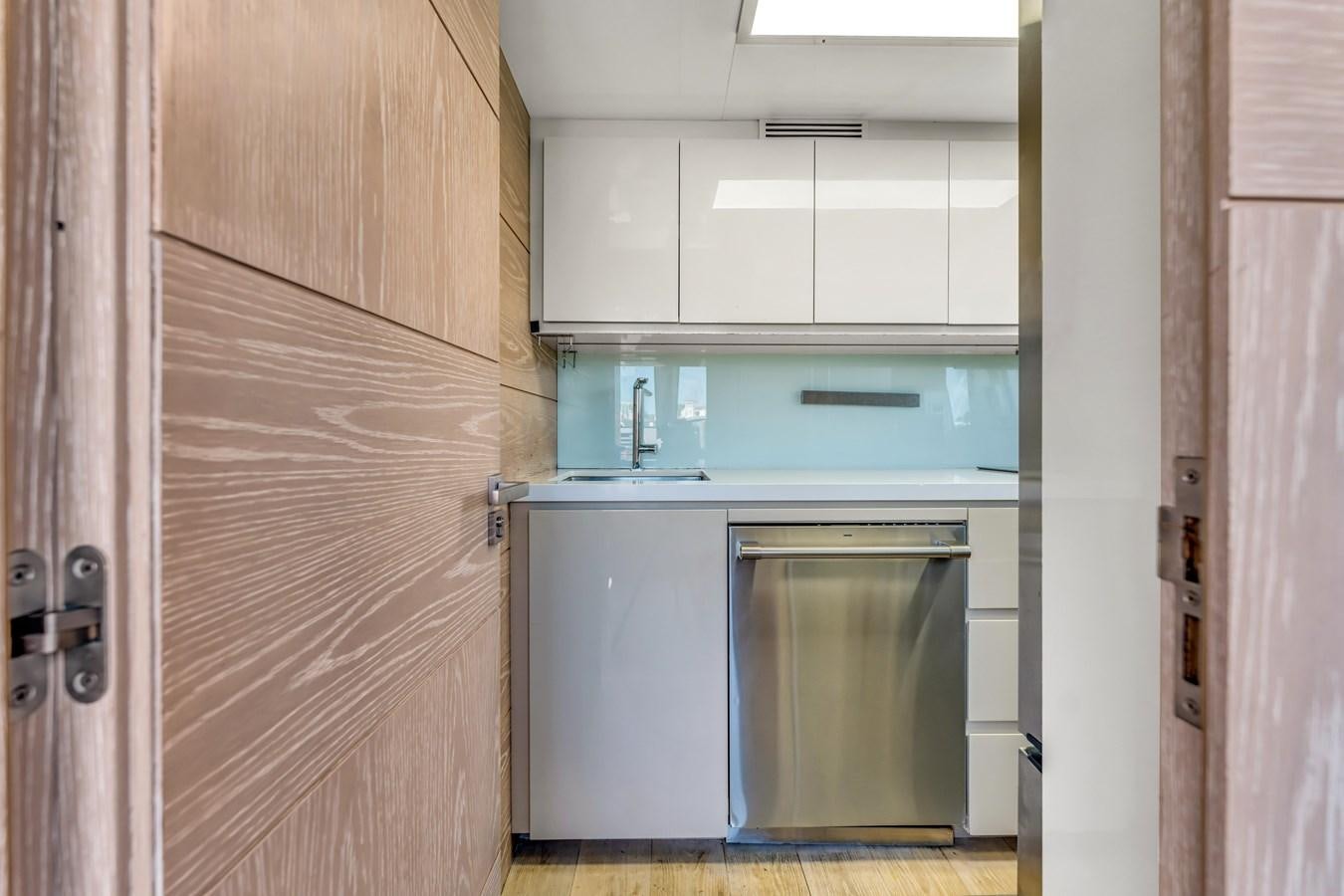 a kitchen with white cabinets aboard SEADUCTION Yacht for Sale