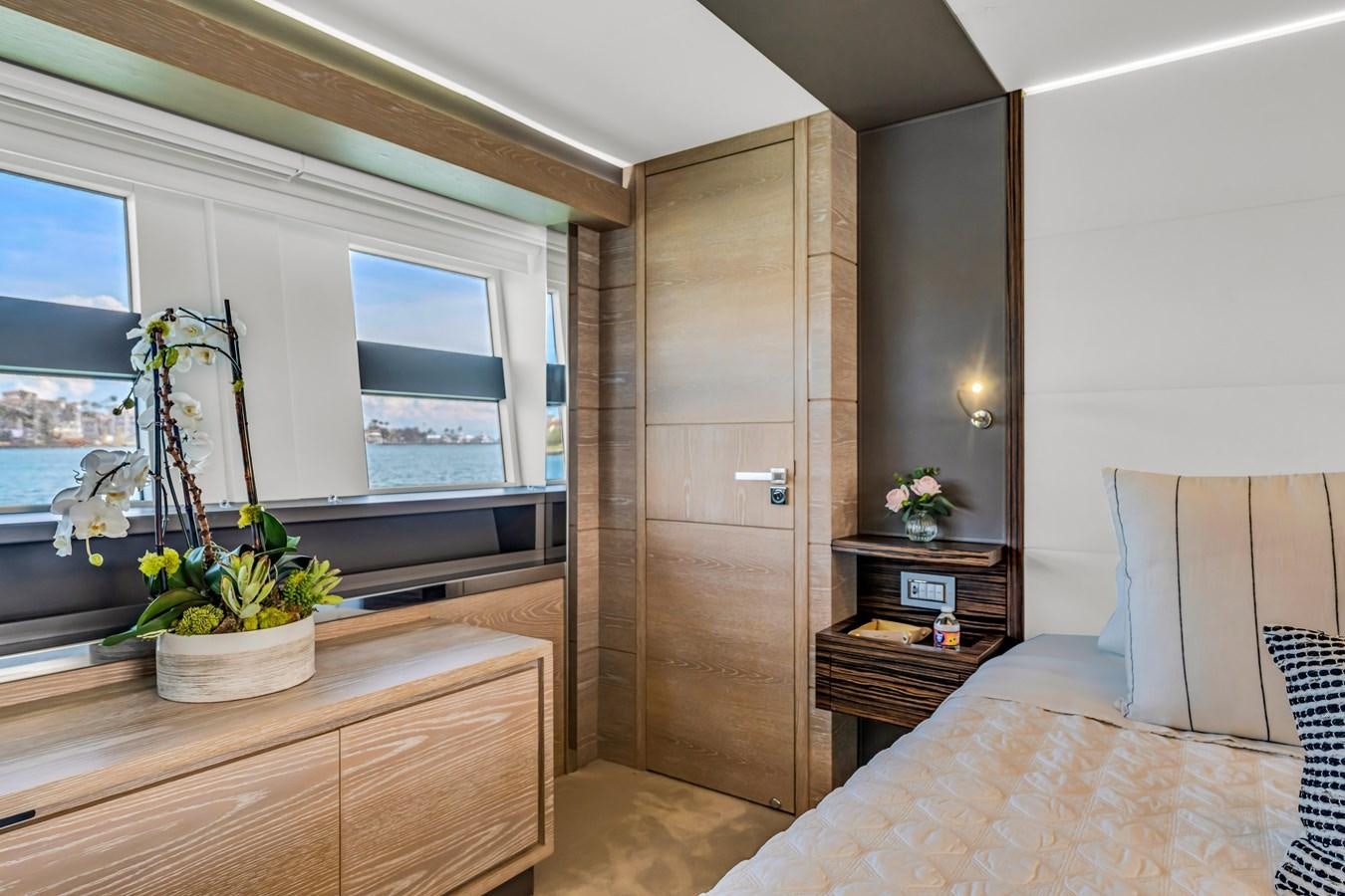 a room with a bed and a plant in it aboard SEADUCTION Yacht for Sale
