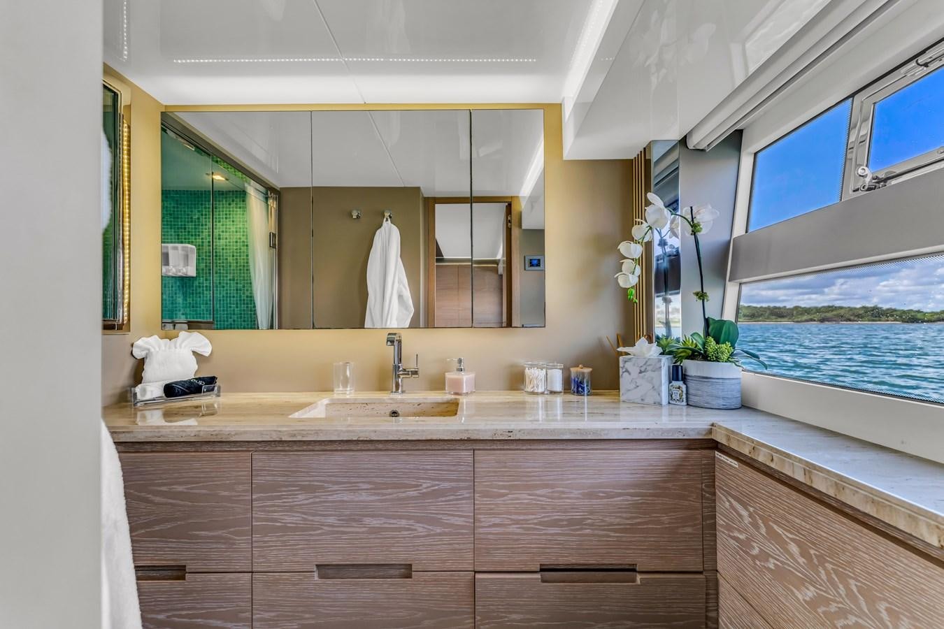 a bathroom with a large mirror aboard SEADUCTION Yacht for Sale