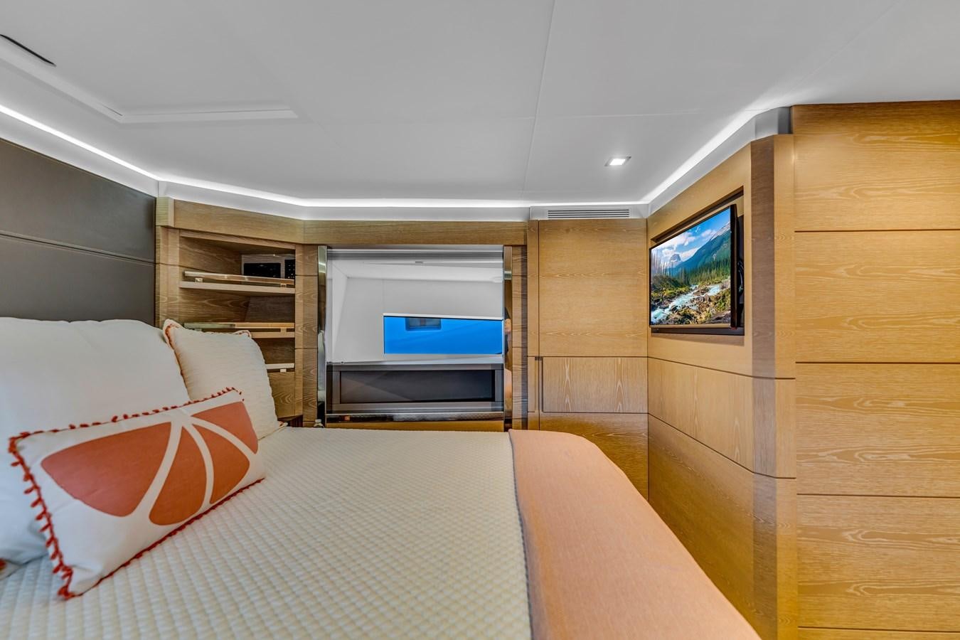 a bedroom with a bed and a tv aboard SEADUCTION Yacht for Sale
