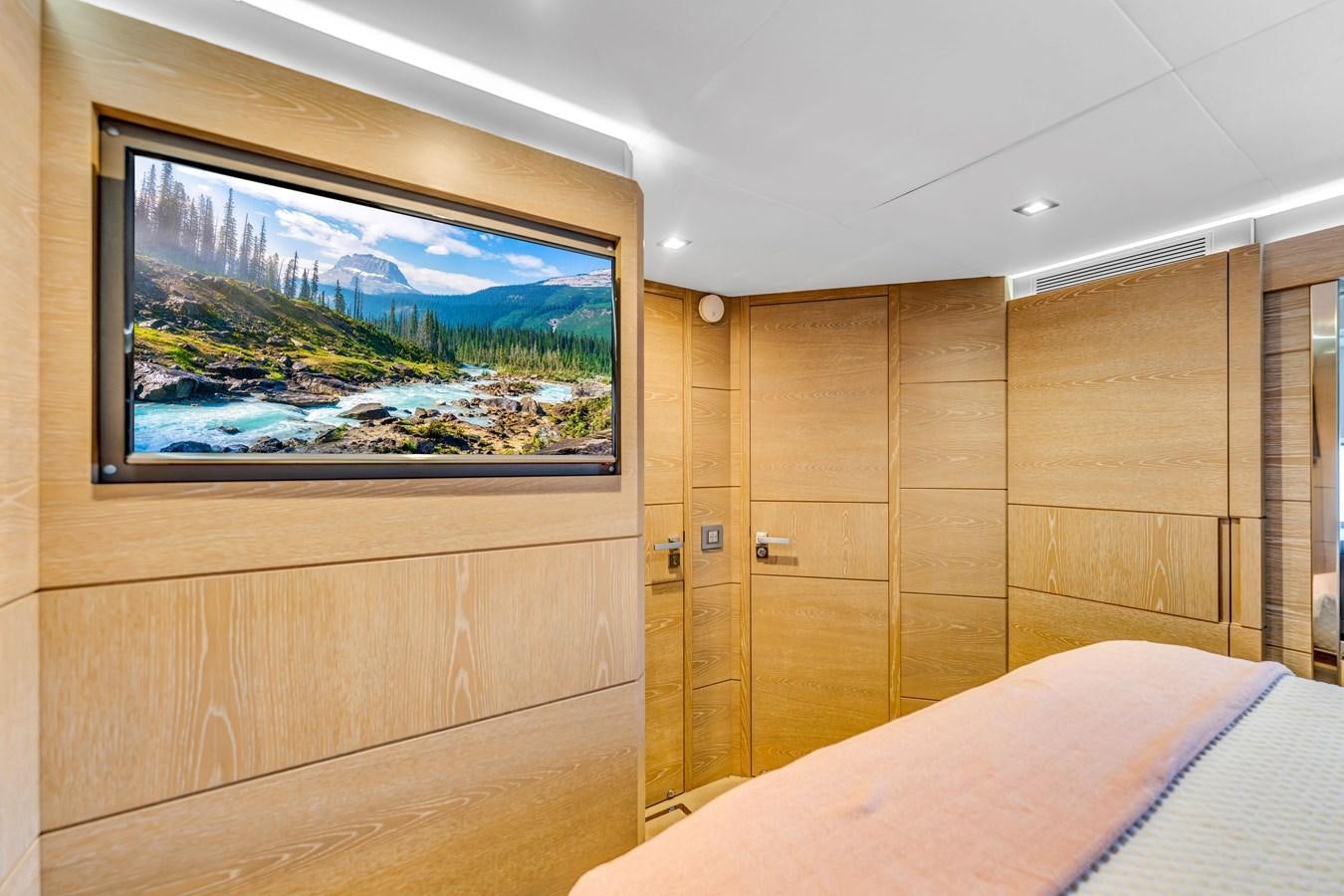 a room with a bed and a television aboard SEADUCTION Yacht for Sale