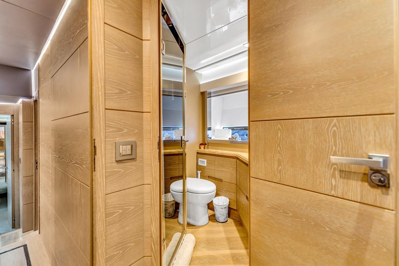 a bathroom with wooden cabinets aboard SEADUCTION Yacht for Sale