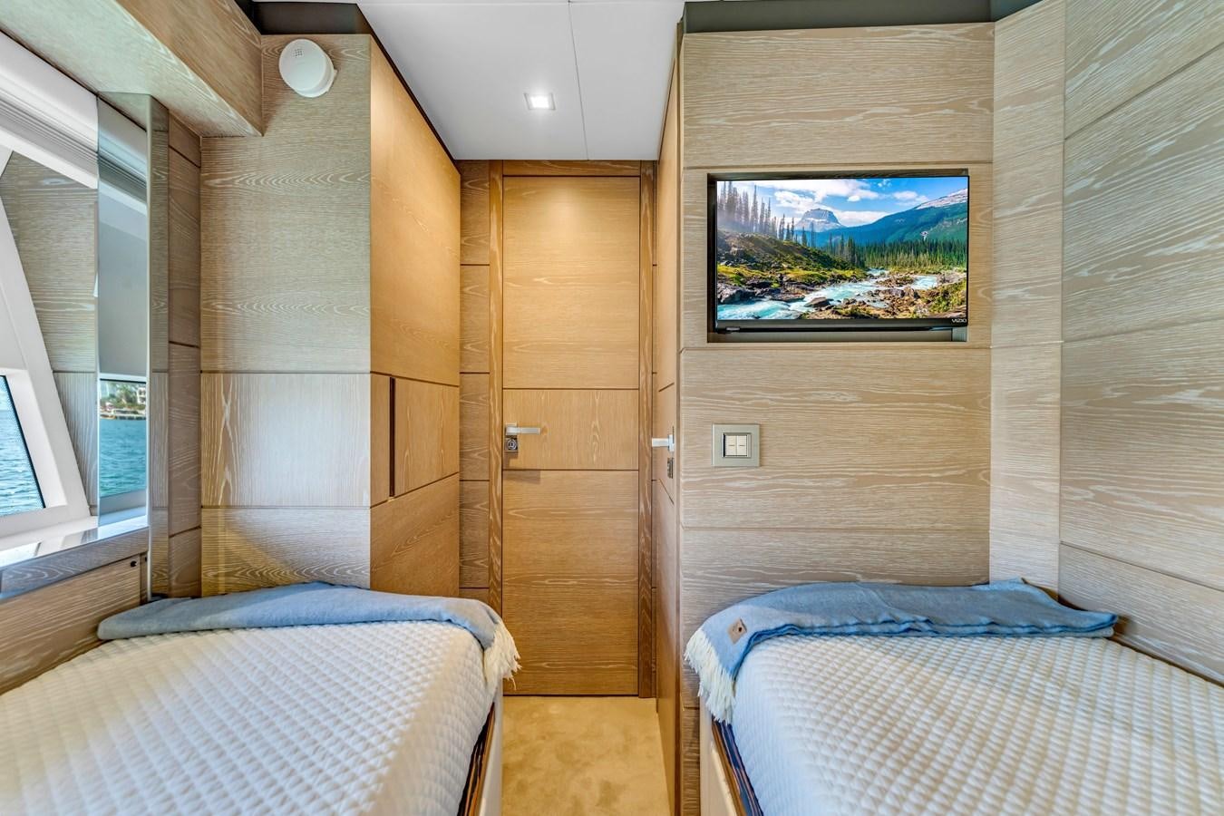 a room with a bed and a television in it aboard SEADUCTION Yacht for Sale