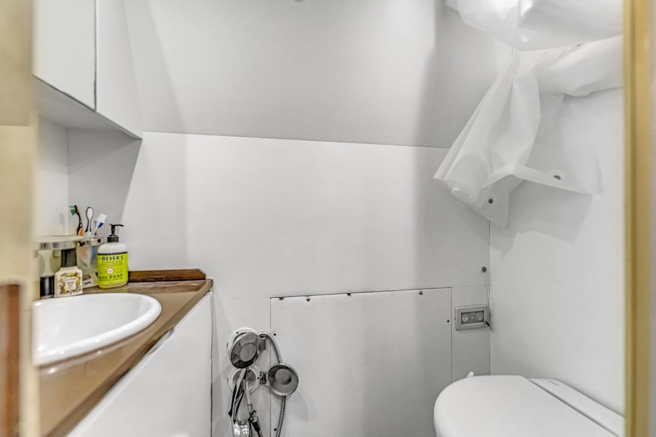 a bathroom with a sink and toilet aboard SEADUCTION Yacht for Sale
