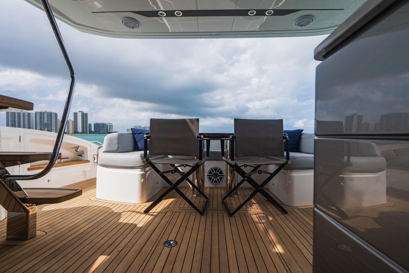 a room with a table and chairs aboard IMAGINE Yacht for Sale