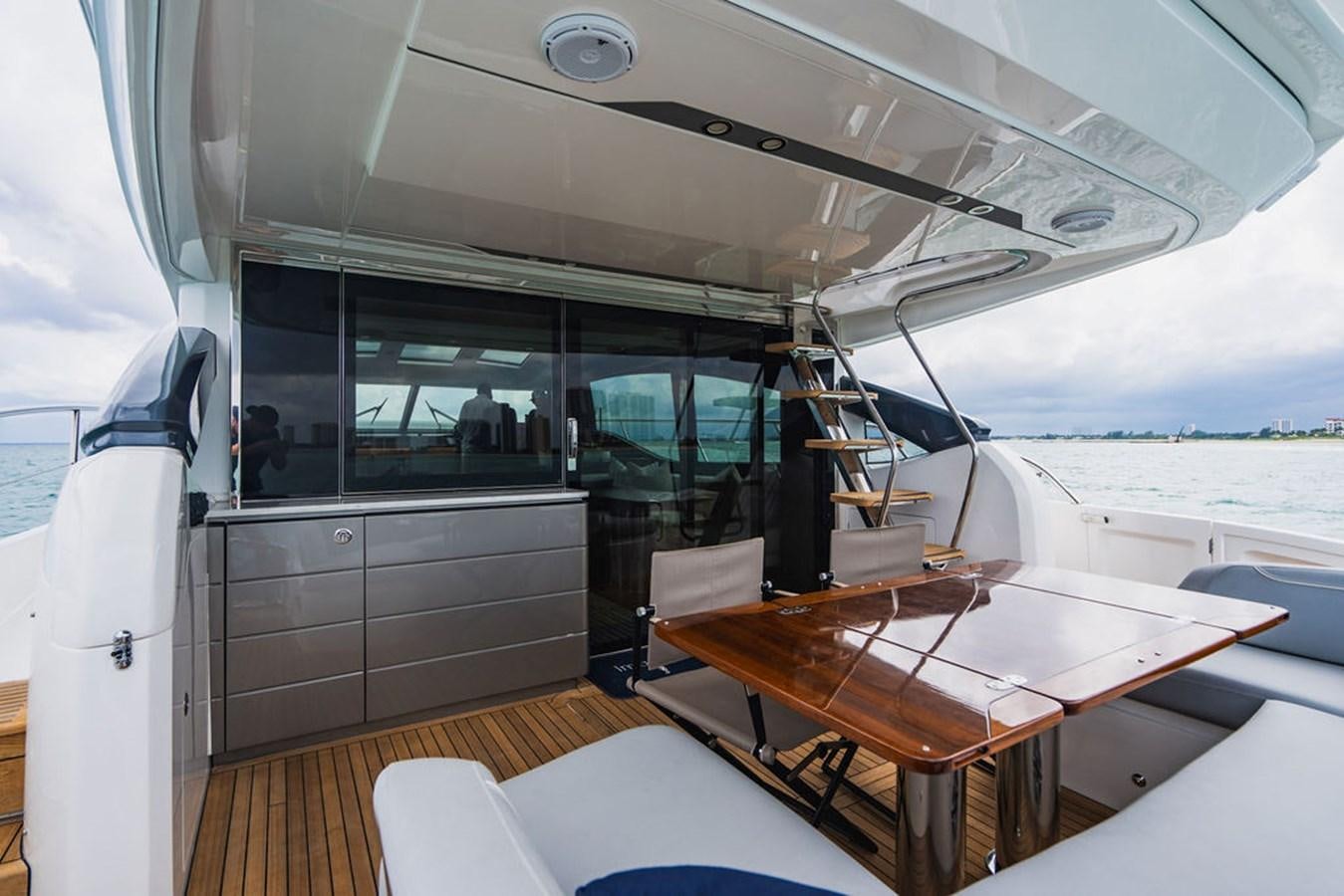 a boat with a table and chairs aboard IMAGINE Yacht for Sale
