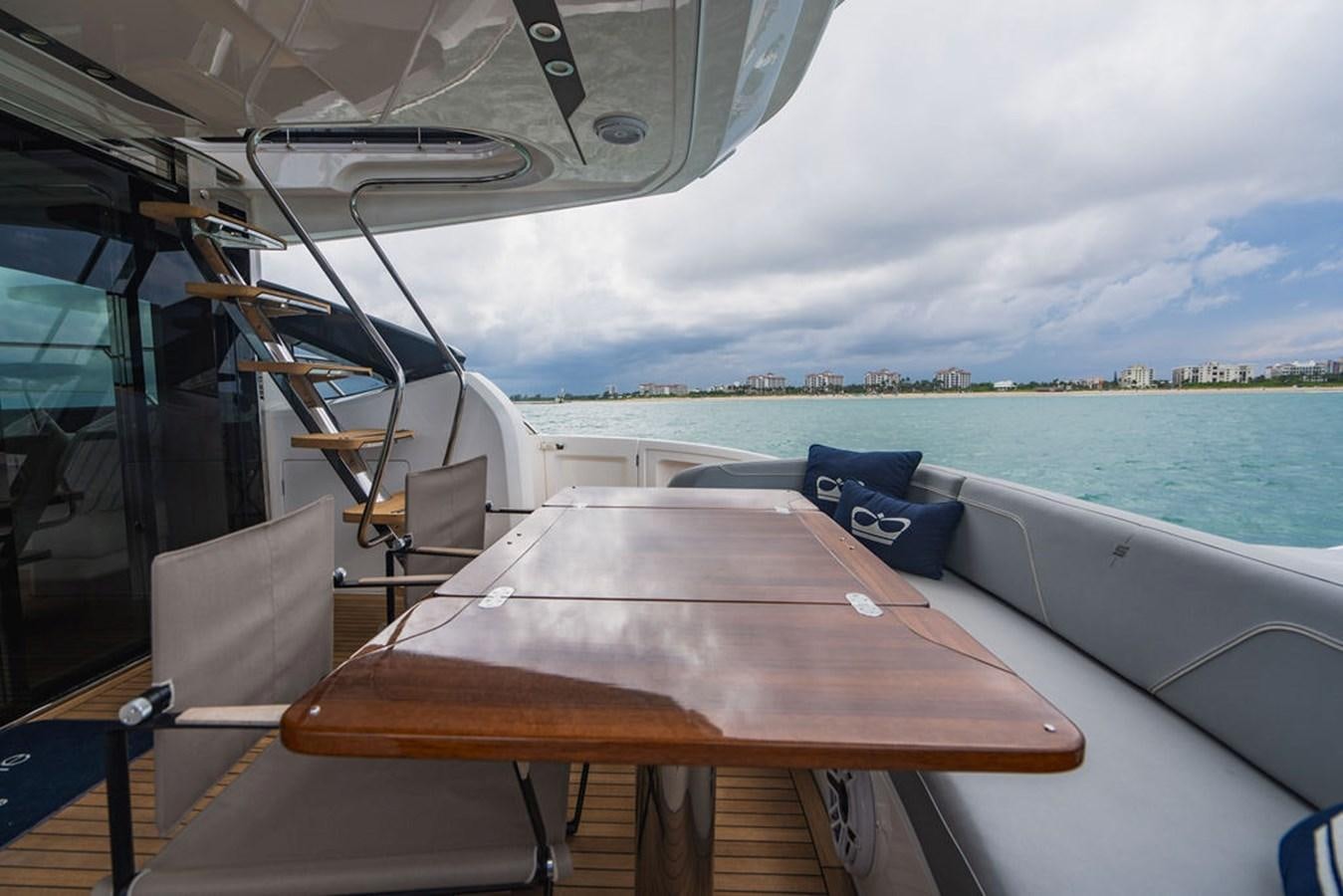 a boat with a table and chairs aboard IMAGINE Yacht for Sale